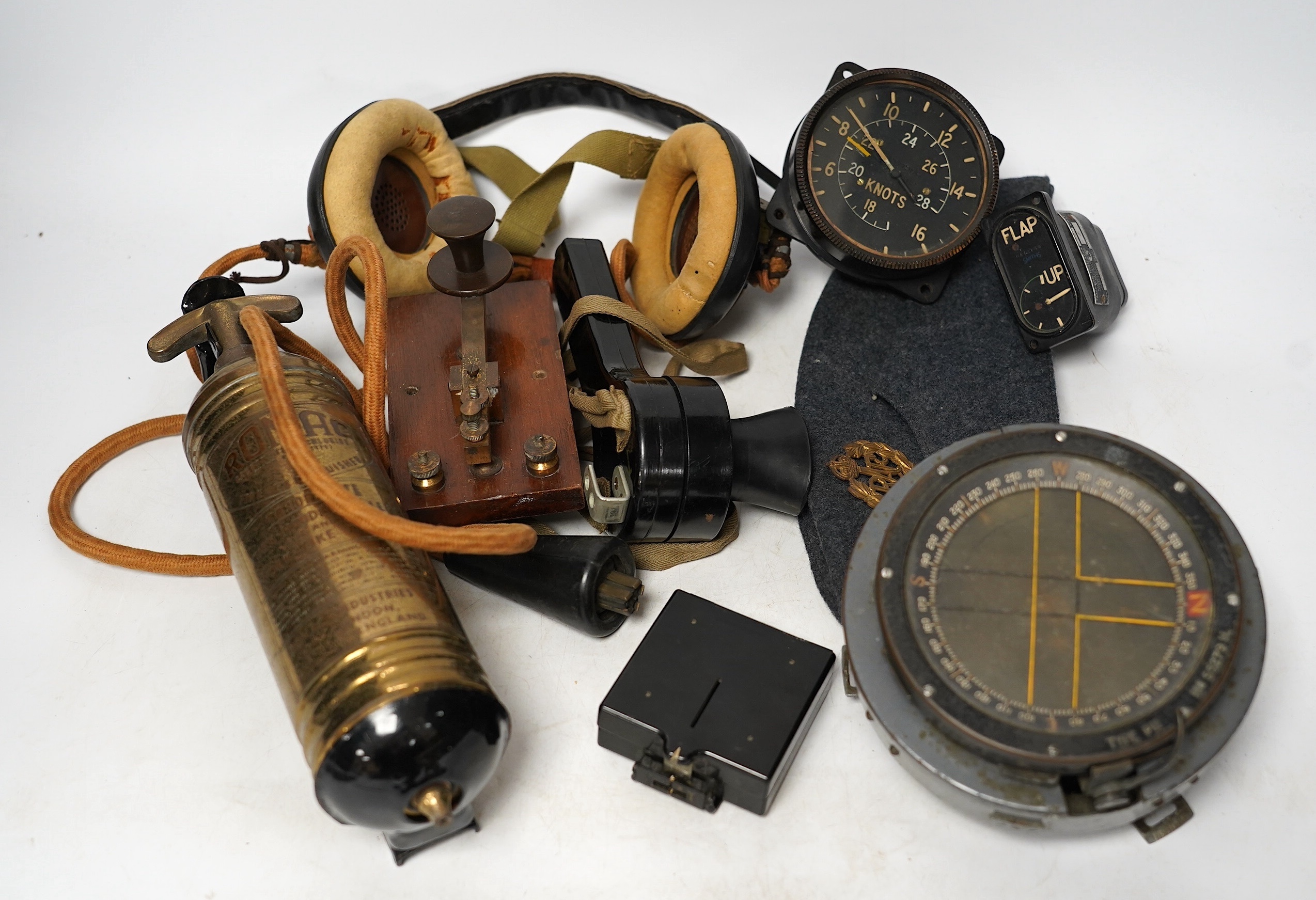 A collection of various WWII military and RAF related items including; an aviation headset, microphone, compass, odometer, morse code tapper, RAF cap, etc. Condition - poor to fair